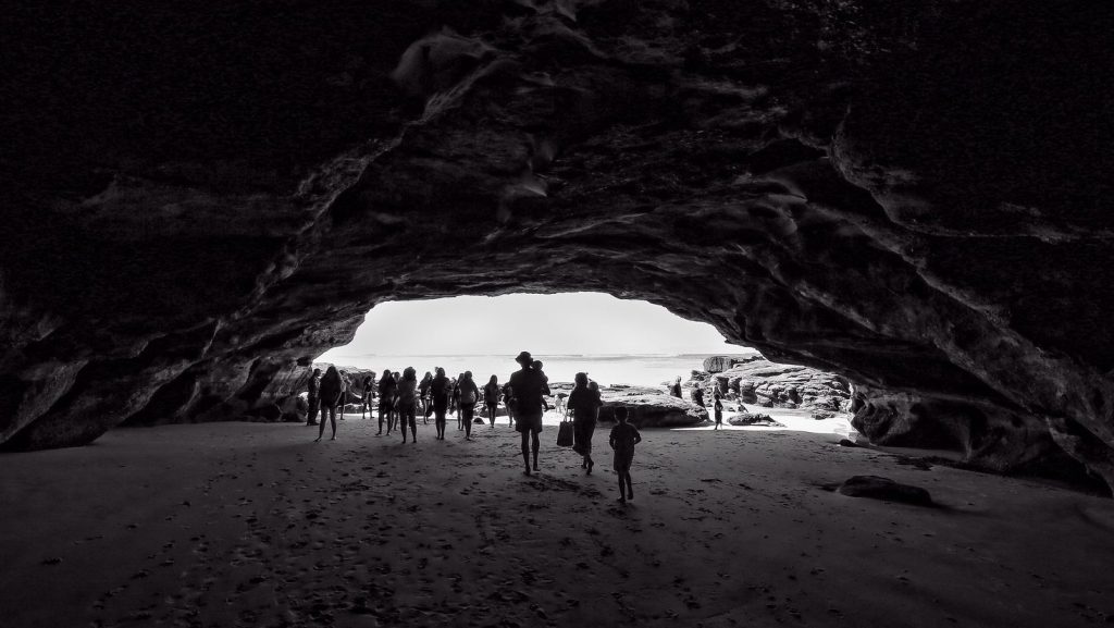 Silhouette view from inside the cave shows the underwater cavity with the half-dozen or so people enabling the viewer to grasp the size.