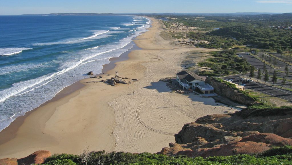 Aerial photo of Redhead Beach from the top of the cliff along the shoreline all the way to Blacksmiths Beach.