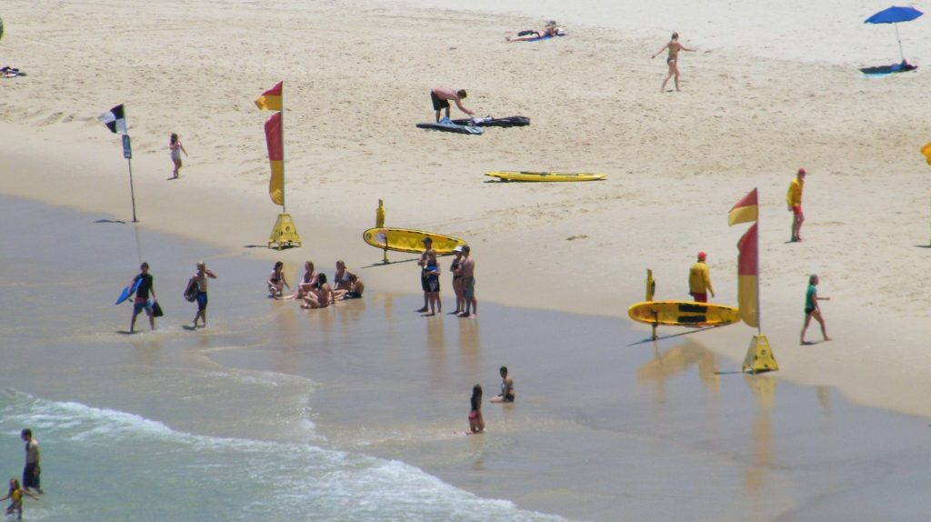 Red and yellow beach flags at a patrolled beach in Australia, marking the safest area to swim.