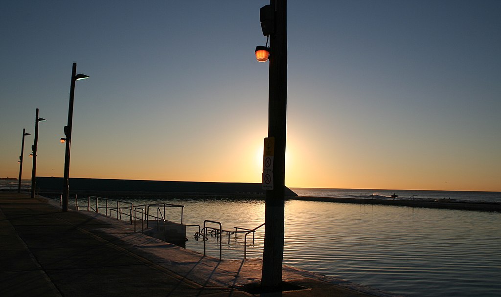 Photograph silhouette at sunrise of Newcastle Ocean Baths.