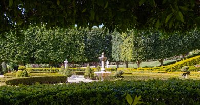 Beautifully manicured grounds, featuring a tiered water fountain hedged in a serene setting.