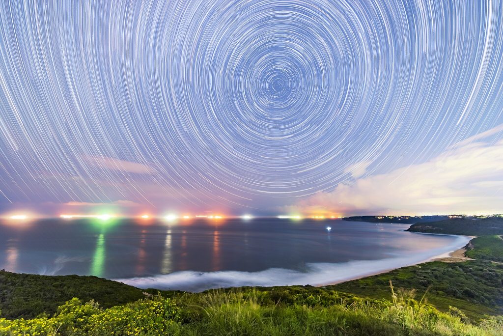 Photo taken with a long exposure, capturing early evening stars over the ocean at Glenrock Conservation Area.